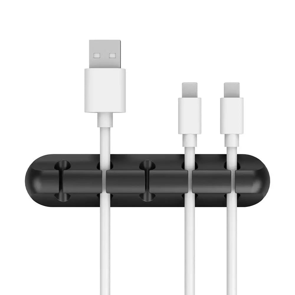 Black silicone cable organizer with four slots holding two charging USB cables