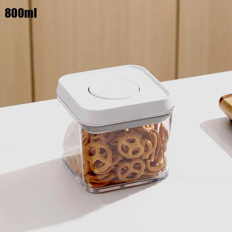 800ml airtight food container with white push-lock lid, clear body filled with snacks